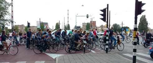 Figure 25 morning rush hour on Weesperziide - Description: Lanes of traffic filled with cyclists taking up the entire street during rush hour.