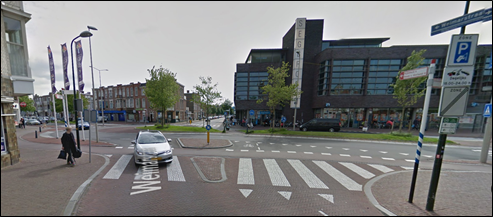 Oval Roundabout with shortcut - Description: A long oval round about in a street that has a built in shortcut for cyclists