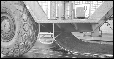 Photo show machine laying adhesive road.
